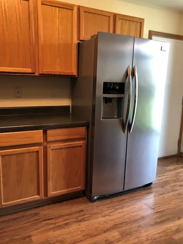 a kitchen with metallic refrigerator freezer and a dishwasher