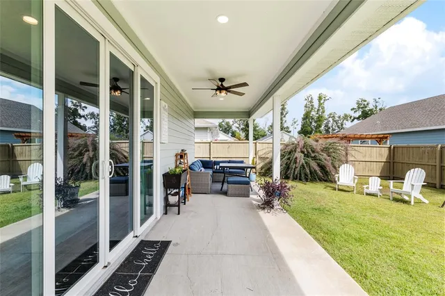 an aerial view of a house with a swimming pool yard and outdoor seating