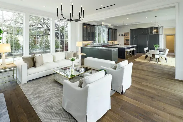 a living room with fireplace furniture and a large window