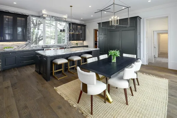 a view of a dining room with furniture a chandelier and wooden floor