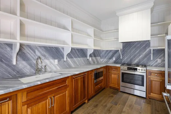 a kitchen with stainless steel appliances granite countertop a stove and a sink