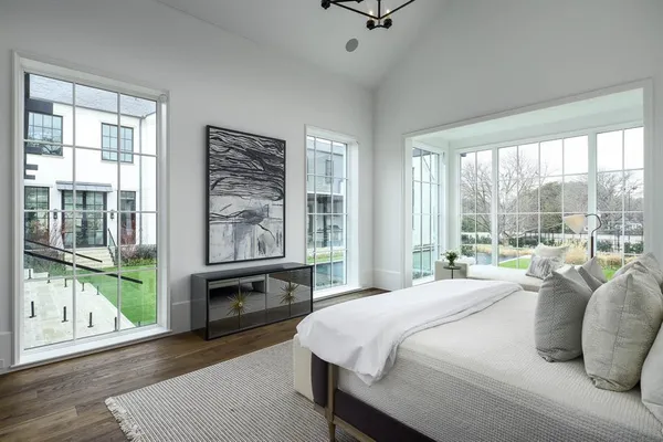 a bedroom with a large bed and a large window