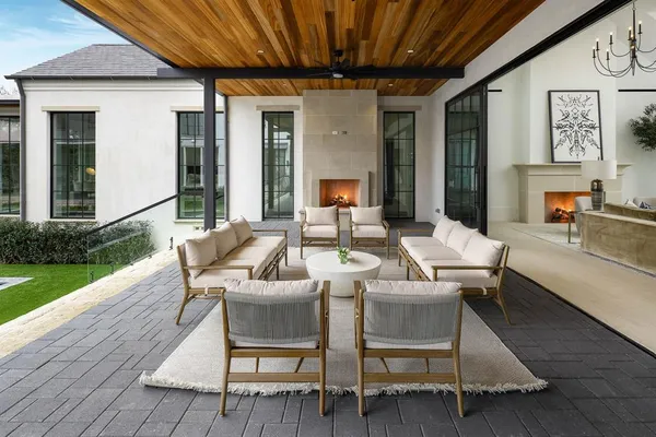 a living room with patio furniture and a wooden floor