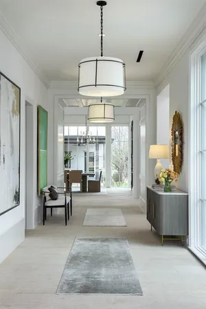 a living room with furniture and floor to ceiling windows
