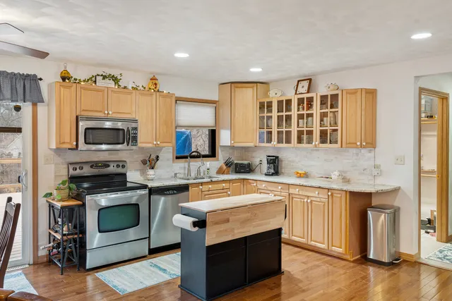 a kitchen with stainless steel appliances granite countertop a stove and a sink