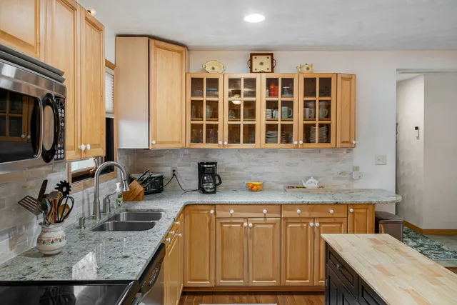 a kitchen with a sink stove and cabinets