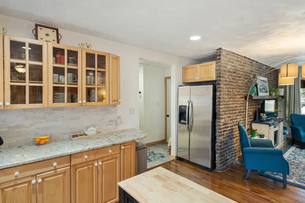 a kitchen with stainless steel appliances granite countertop a refrigerator and a sink