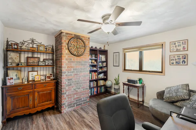 a living room with furniture wooden floor and window