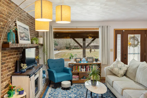 a living room with fireplace furniture and a flat screen tv