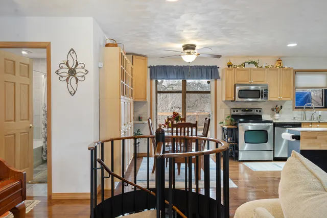 a kitchen with stainless steel appliances granite countertop a refrigerator stove top oven and sink