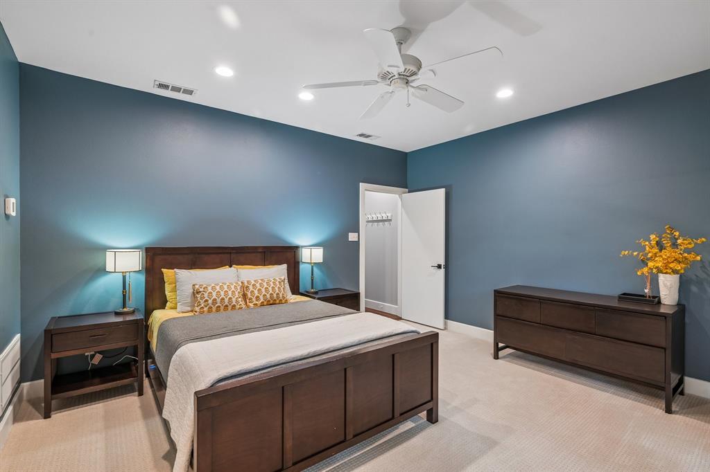3553 Wheeler Street Dallas, TX 75209 - Photo 25 of 35 Primary bedroom with blue walls, dark wood furniture, ceiling fan, walk-in closet access, and recessed lighting