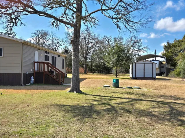 a view of yard with swimming pool and seating area