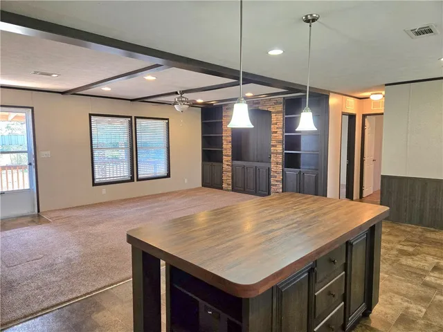 an open kitchen with a table and chairs
