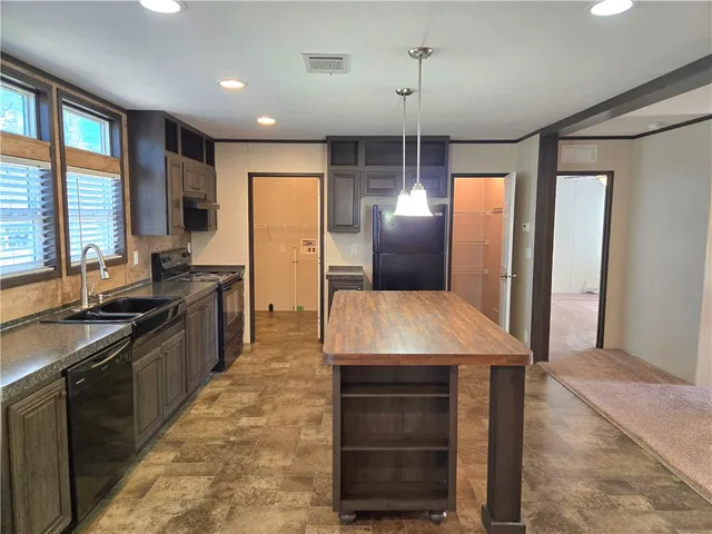 a kitchen with kitchen island a counter top space appliances and a counter space
