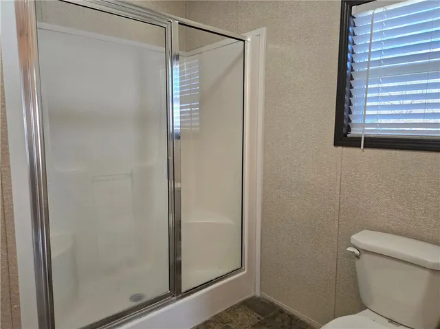 a bathroom with a shower and a toilet