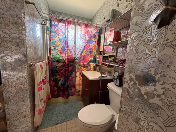 a bathroom with a toilet sink and mirror