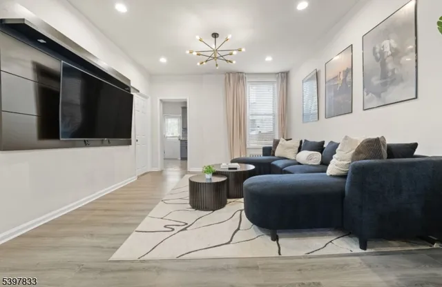 a living room with furniture a rug and a flat screen tv