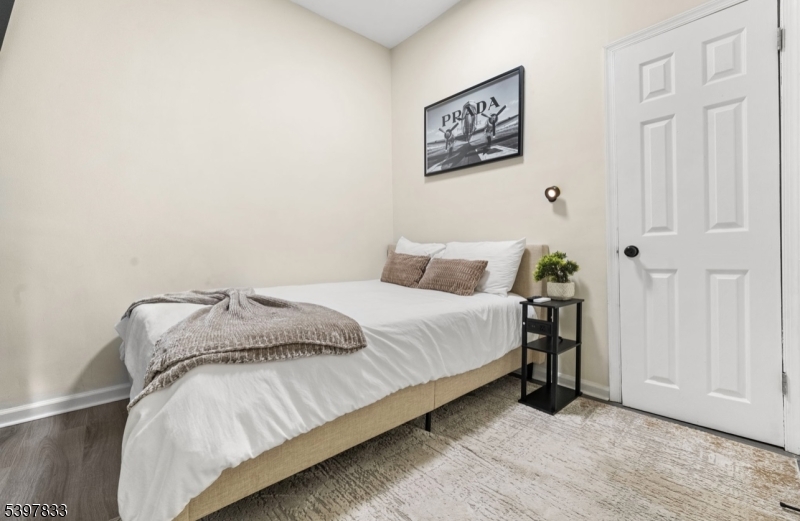 39 Emmet Street Newark, NJ 07114 - Photo 5 of 7 a bedroom with a bed and a painting on the wall