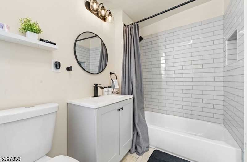 39 Emmet Street Newark, NJ 07114 - Photo 6 of 7 a bathroom with a sink a toilet and a bathtub