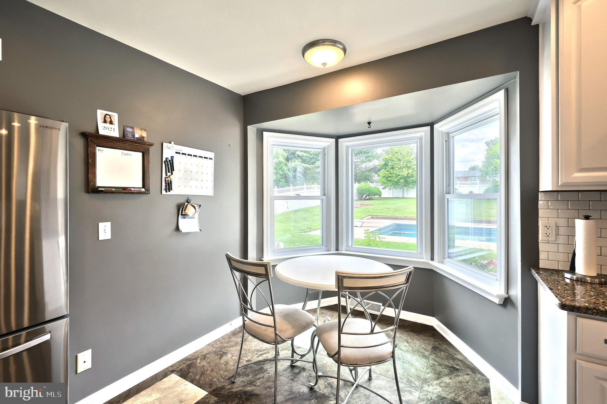 2420 Sutton Road York, PA 17403 - Photo 13 of 49 a view of a dining room with furniture large windows and wooden floor