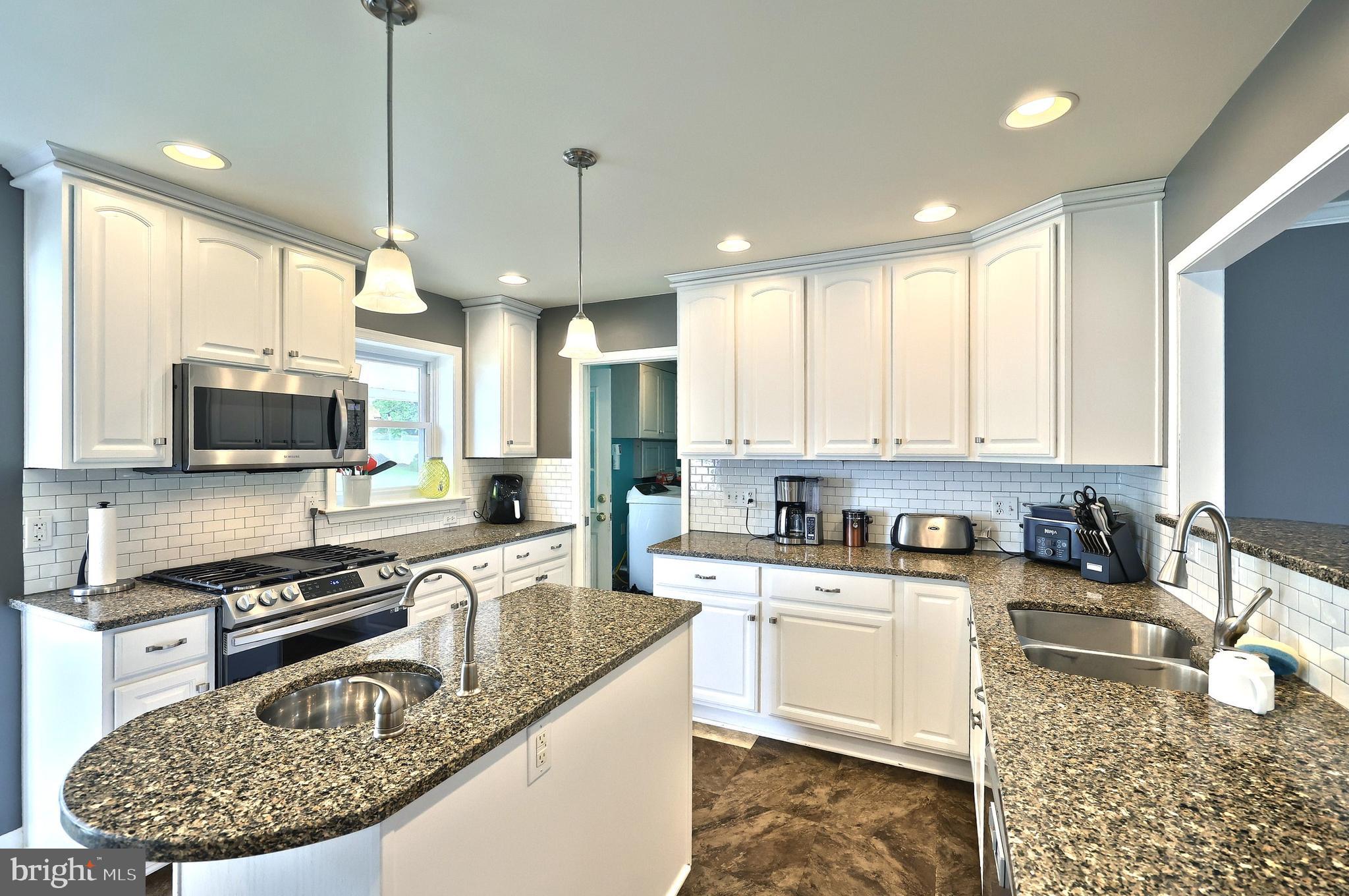 2420 Sutton Road York, PA 17403 - Photo 14 of 49 a kitchen with stainless steel appliances granite countertop a sink stove and refrigerator