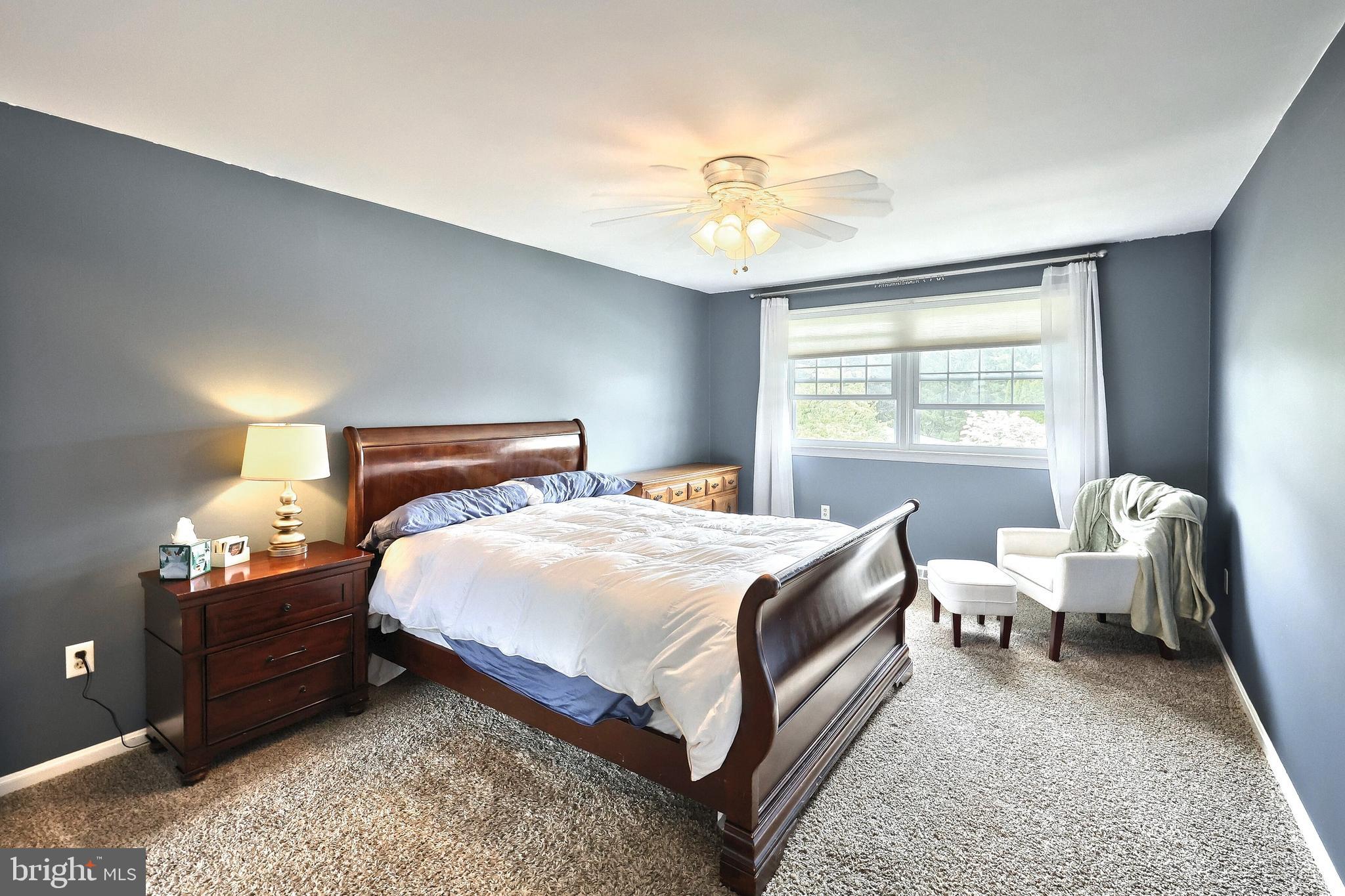 2420 Sutton Road York, PA 17403 - Photo 22 of 49 a bedroom with a bed and a chandelier