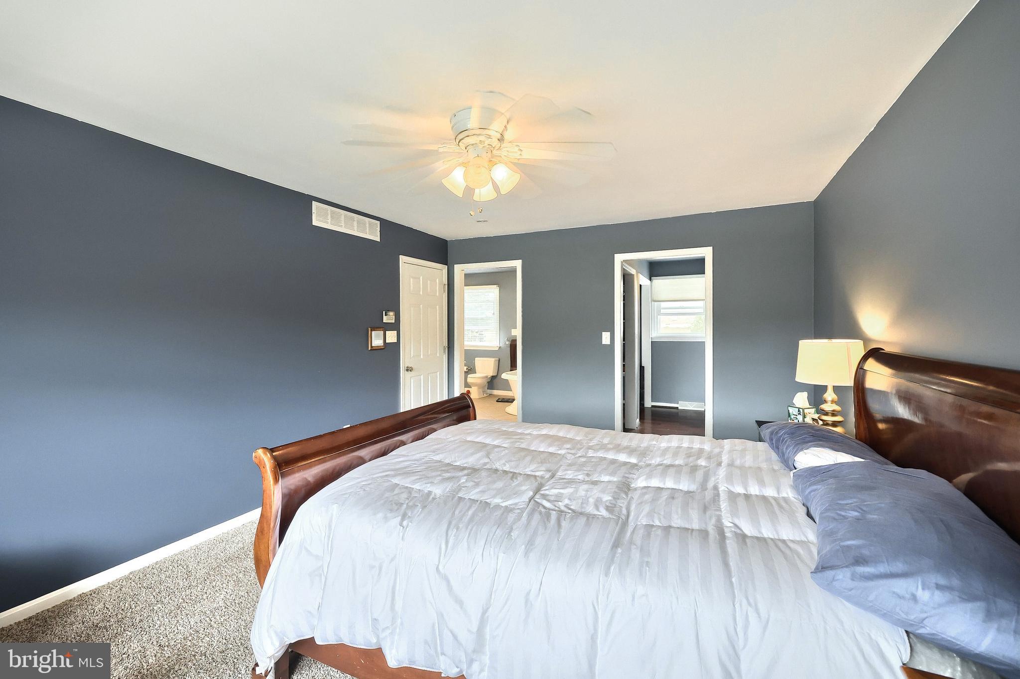 2420 Sutton Road York, PA 17403 - Photo 23 of 49 a bedroom with a large bed and a chandelier