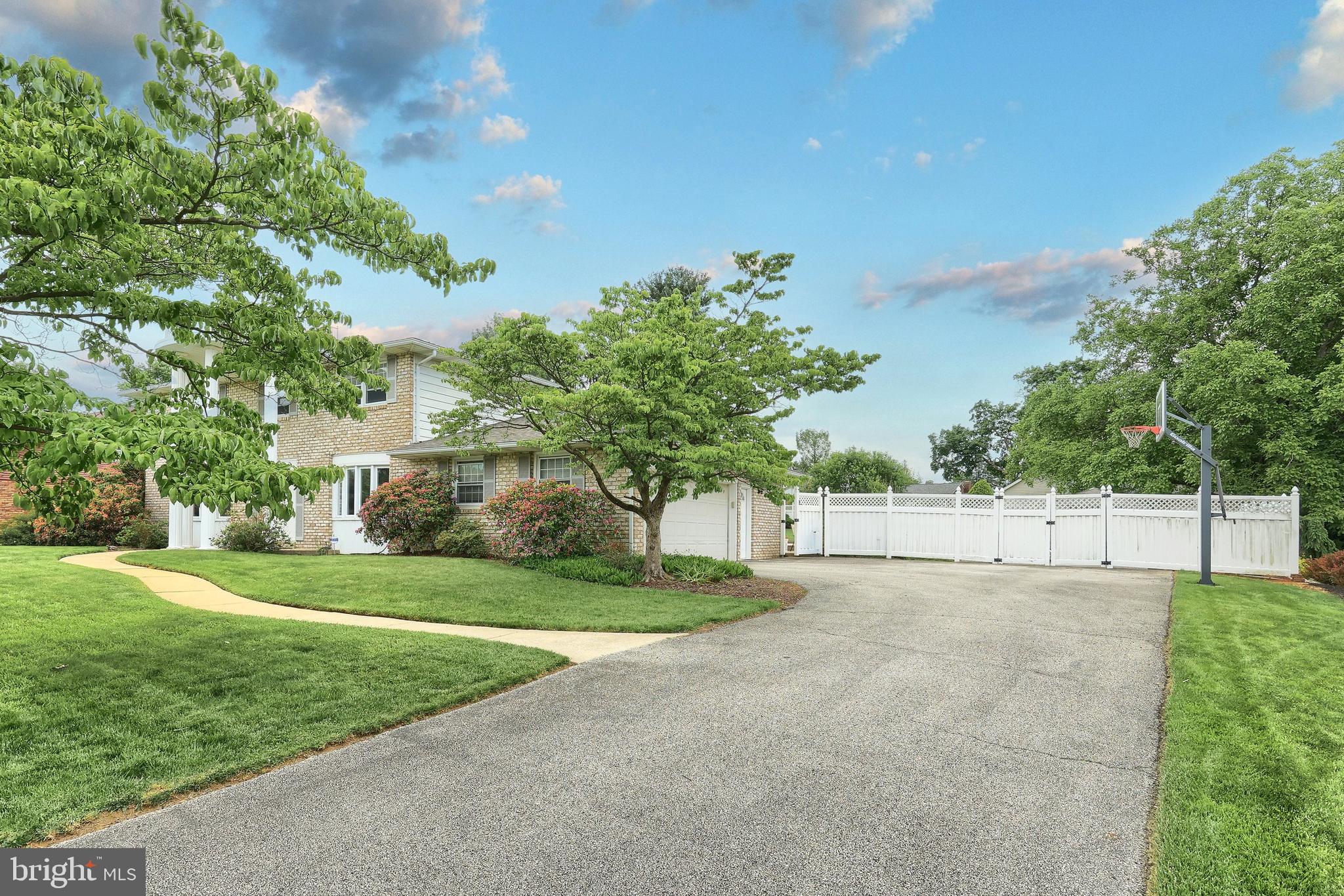 2420 Sutton Road York, PA 17403 - Photo 3 of 49 a view of a house with a big yard and large trees