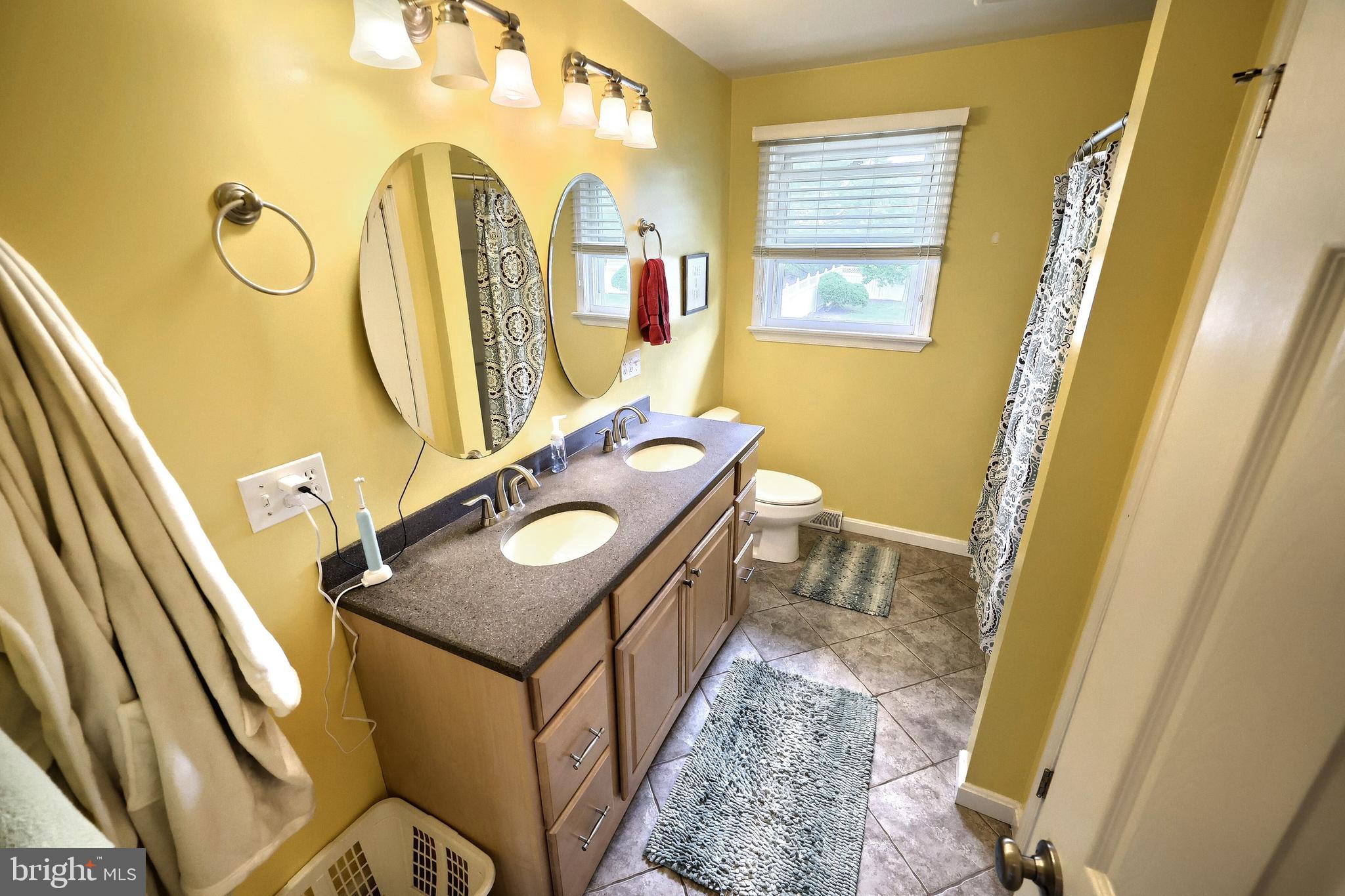 2420 Sutton Road York, PA 17403 - Photo 31 of 49 a bathroom with a granite countertop sink and a mirror