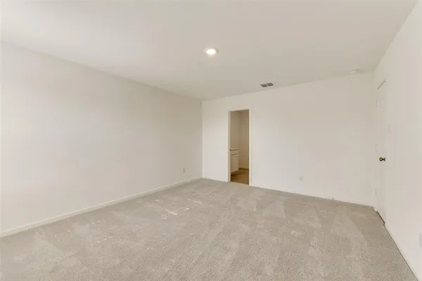 a view of a big room with wooden cabinet and windows