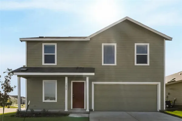 a front view of a house with garage