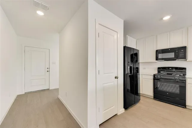 a view of a kitchen with a sink and a refrigerator