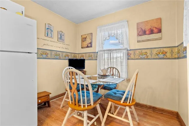 a view of a dining room with furniture and a chandelier