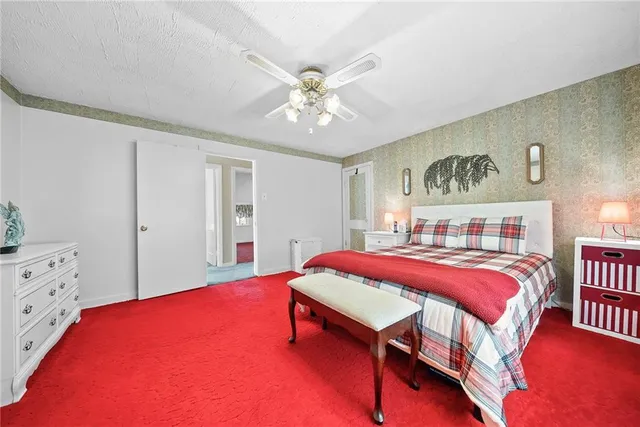 a bedroom with a bed and a dresser in it