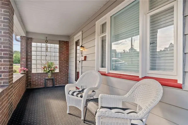 a living room with furniture and floor to ceiling windows