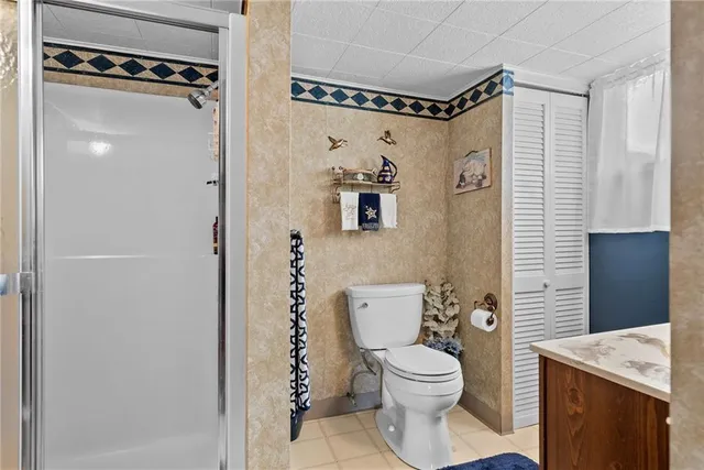 a bathroom with a toilet a sink and shower
