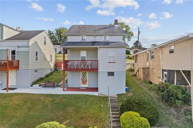a view of a house with pool plants and large trees