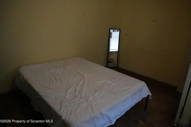 a white toilet sitting next to a shower curtain