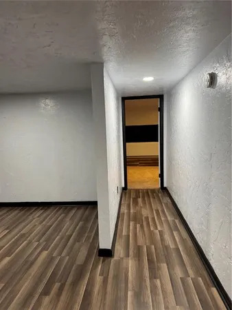 a view of a room with wooden floor and chair