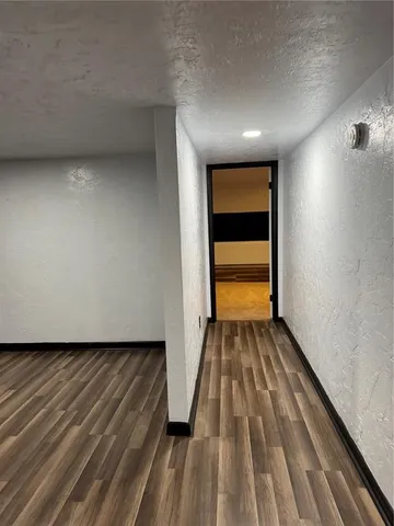 a view of a room with wooden floor and chair