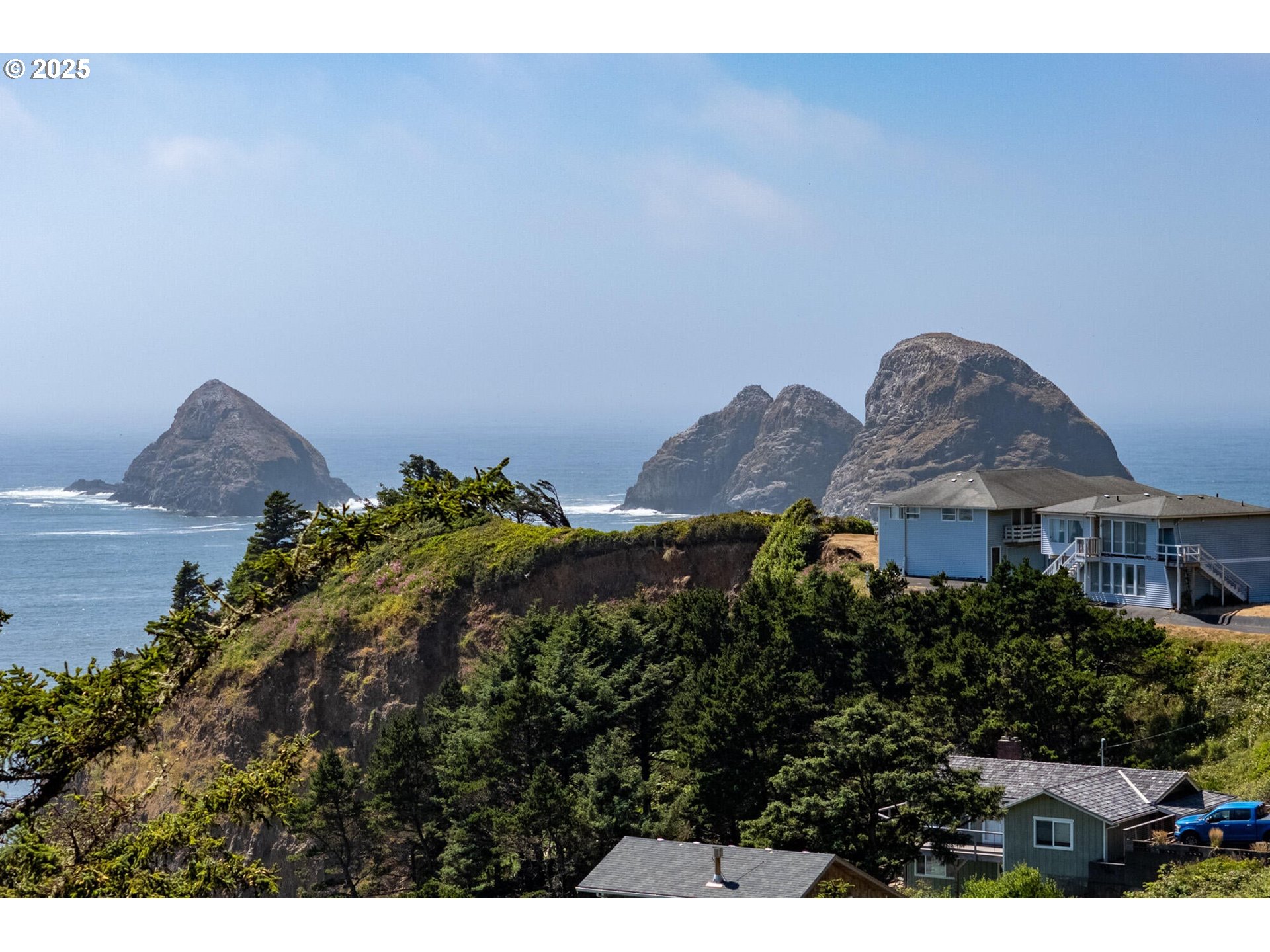15 Chinook Avenue, Unit 5 Oceanside, OR 97134 - Photo 18 of 19 a view of a house with a yard and a large window