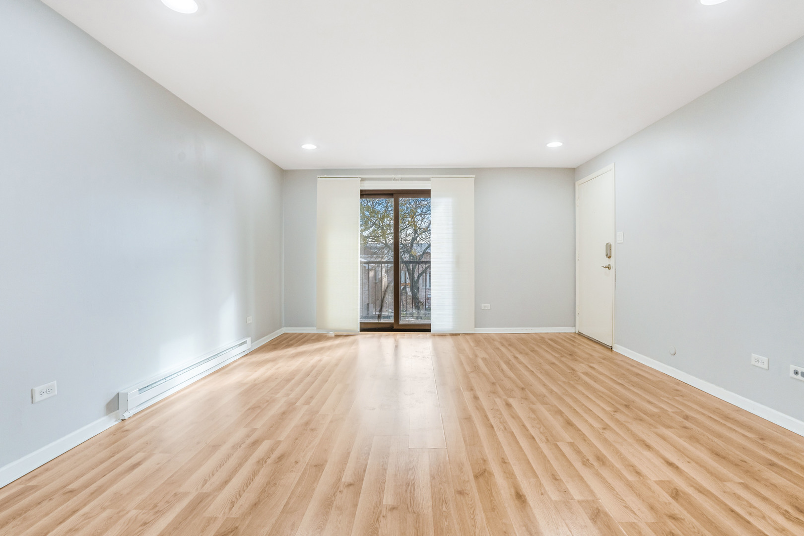6728 West 64th Place, Unit 2B Chicago, IL 60638 - Photo 4 of 14 wooden floor in an empty room with a window