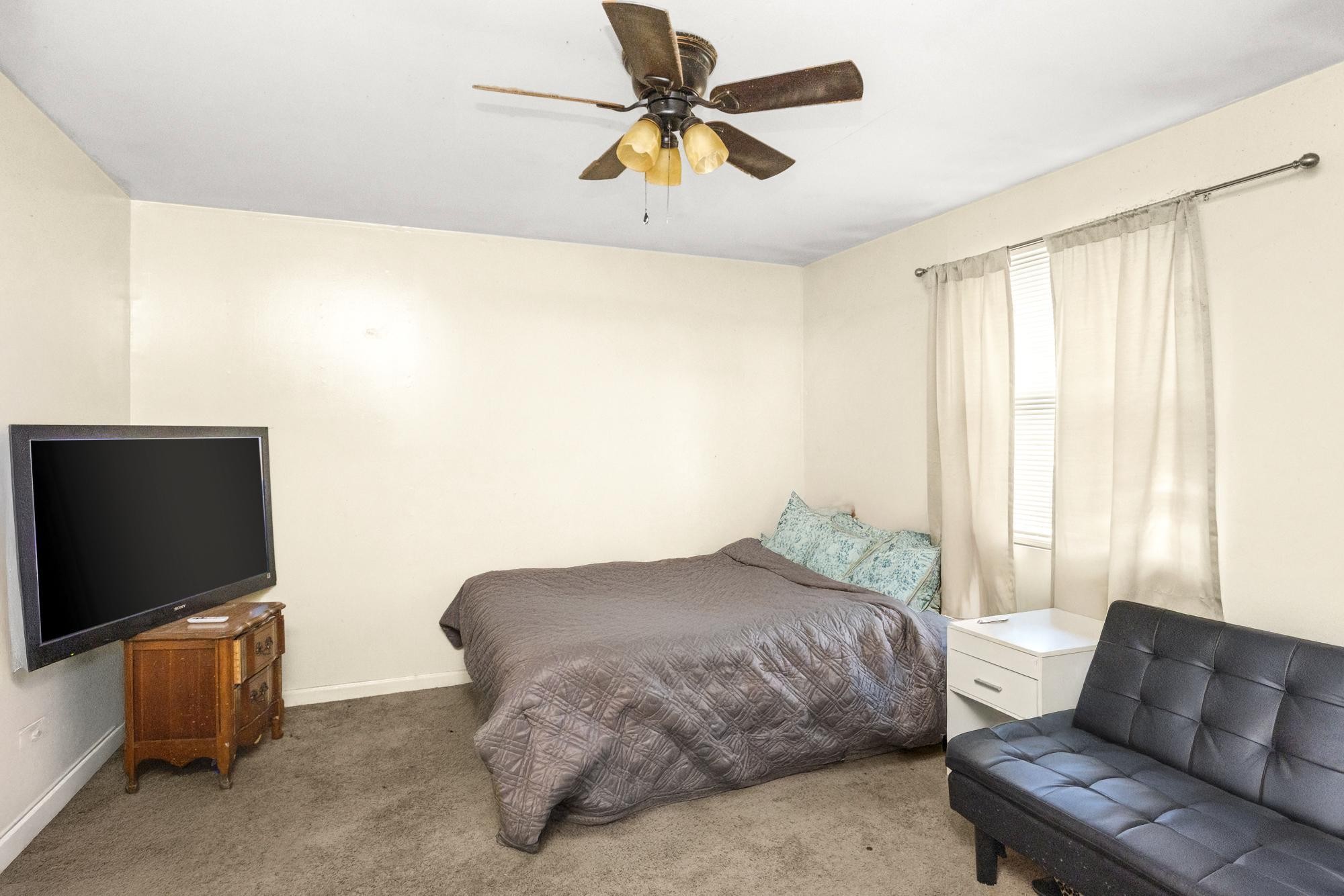 208 Leeshan Court Antioch, TN 37013 - Photo 13 of 31 a bedroom with a bed and a flat screen tv