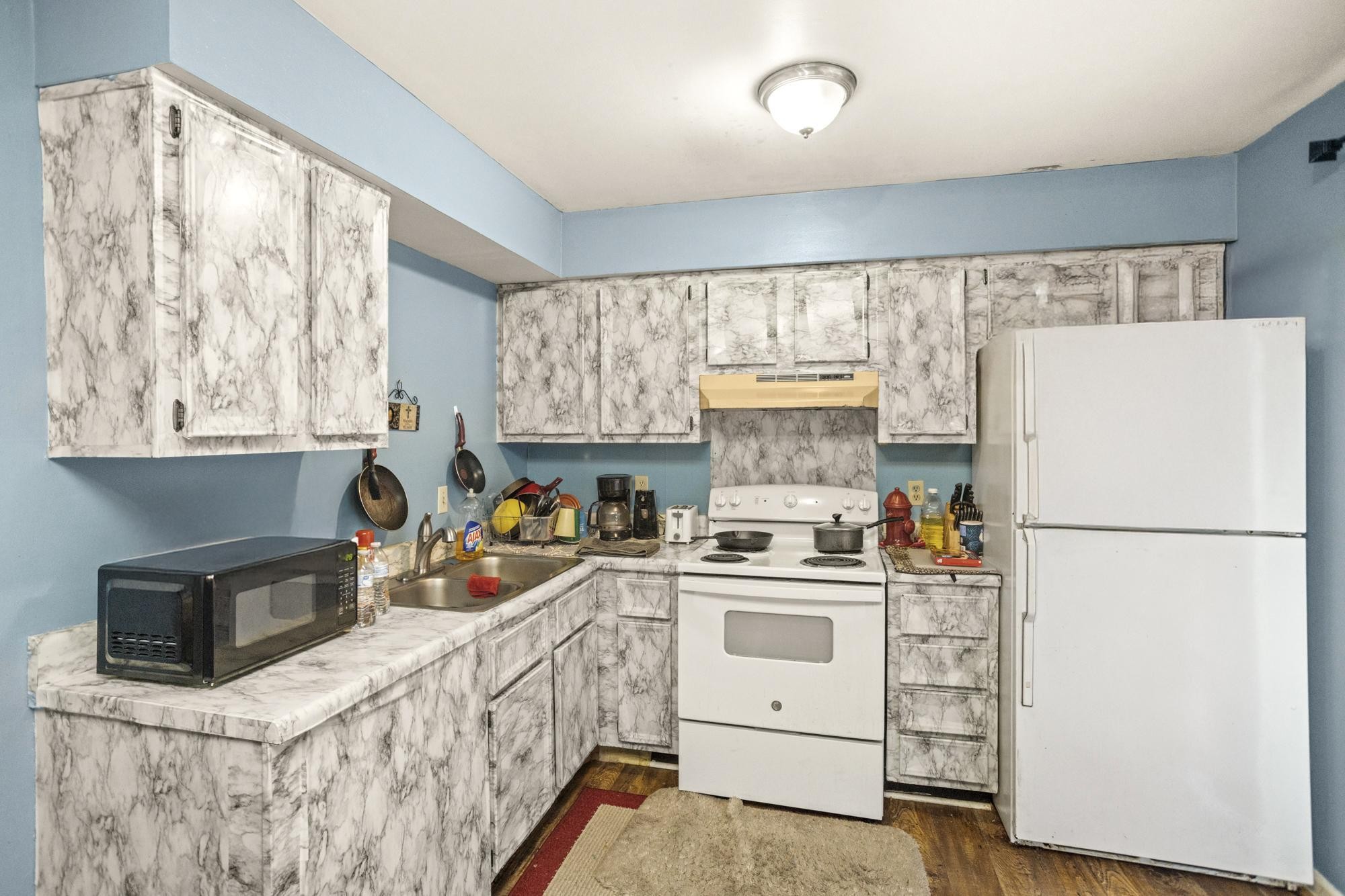208 Leeshan Court Antioch, TN 37013 - Photo 16 of 31 a kitchen with a refrigerator a stove a microwave a sink and cabinets
