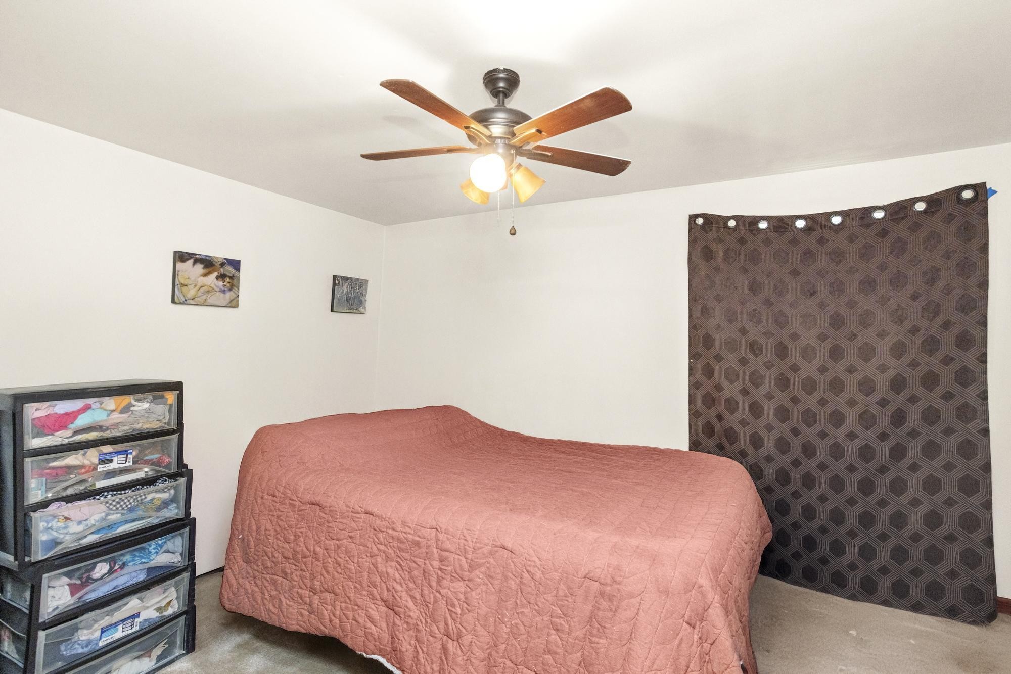 208 Leeshan Court Antioch, TN 37013 - Photo 24 of 31 a bedroom with a bed and a ceiling fan