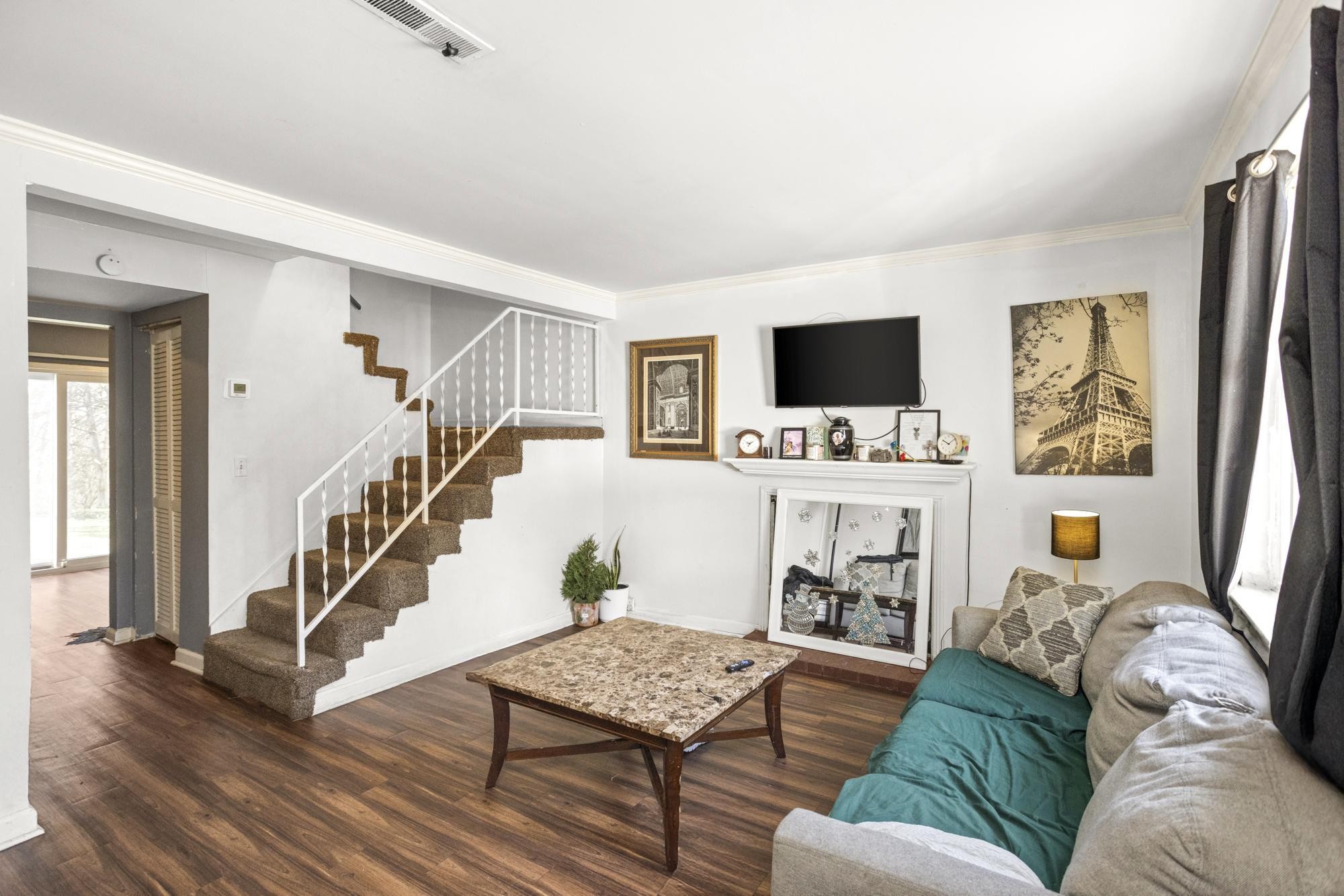 208 Leeshan Court Antioch, TN 37013 - Photo 3 of 31 a living room with furniture and a flat screen tv with wooden floor