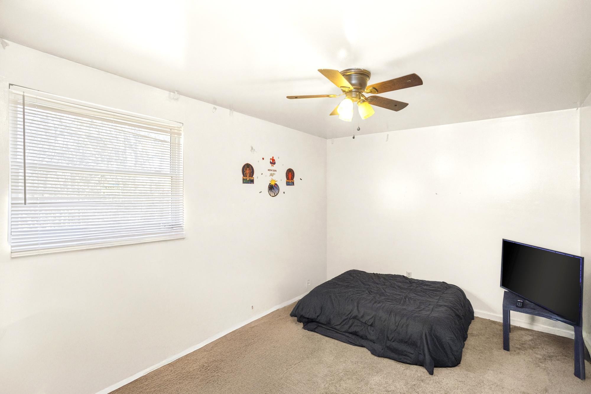 208 Leeshan Court Antioch, TN 37013 - Photo 10 of 31 a bedroom with a bed and a chandelier fan