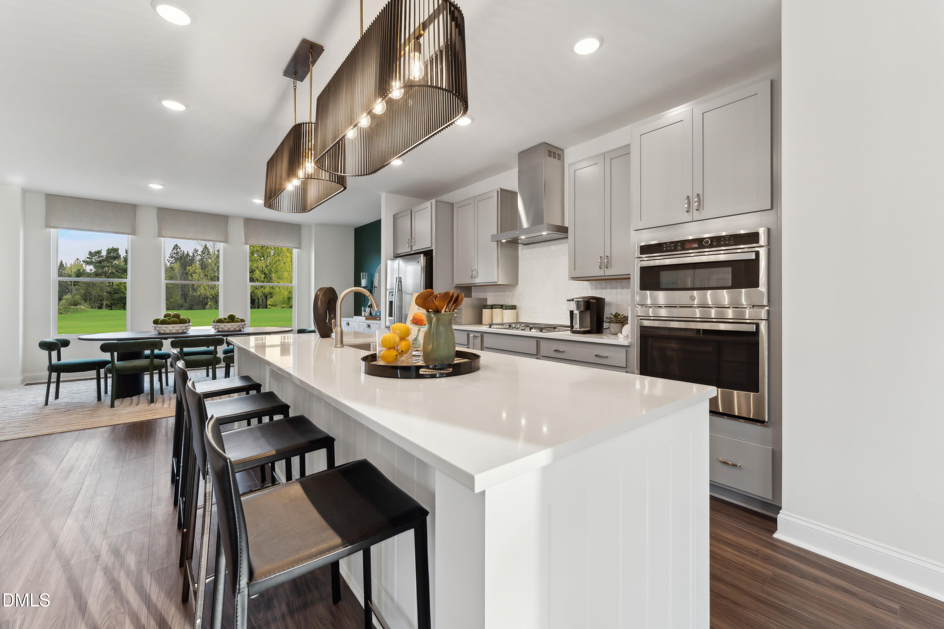10632 Pleasant Branch Drive Raleigh, NC 27614 - Photo 8 of 35 a kitchen with stainless steel appliances a table chairs and a refrigerator