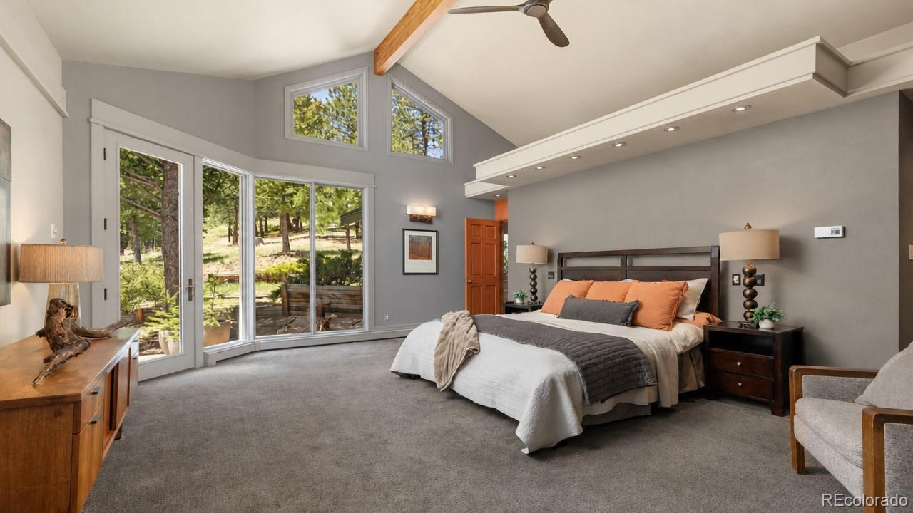 1323 South Snyder Gulch Road Evergreen, CO 80439 - Photo 18 of 47 a bedroom with a bed and a large window