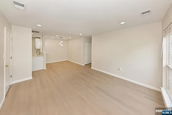 an empty room with a empty space and windows